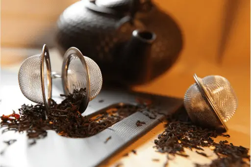 black tea leaves with kettle
