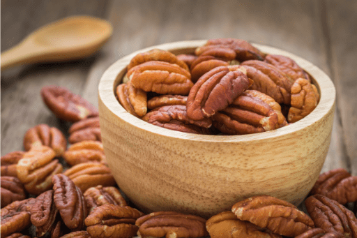 Pecan nuts dry fruit in a wooden bowl