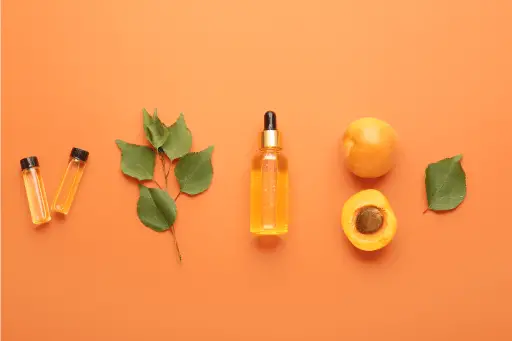 Bottle of apricot oil with apricot fruit