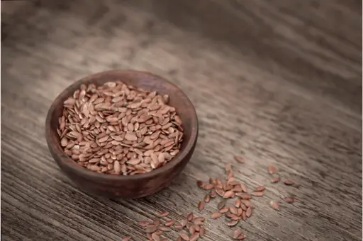Flax seeds in wooden bowl