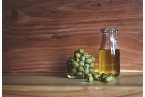 Olive oil bottle with olive fruits