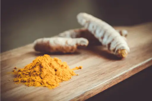Turmeric powder on wooden table