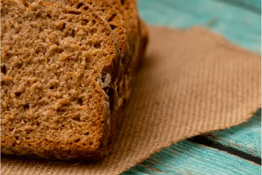 Slices of brown bread over wooden table