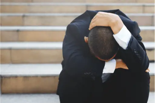 Man in stress sitting on stairs