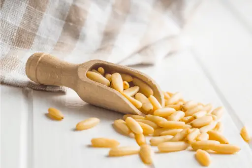 Pine nuts on wooden table