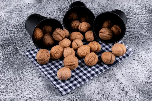 Walnuts in black buckets