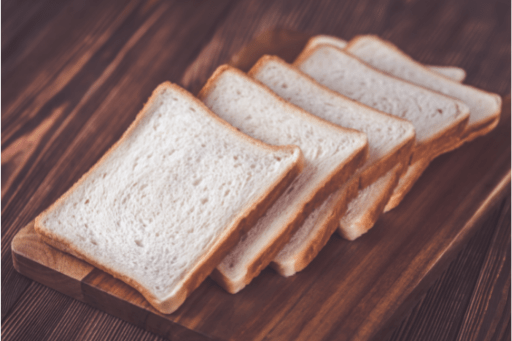 Slices of white bread on wooden table