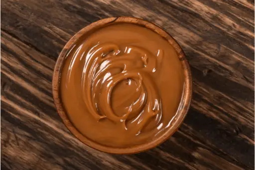 Caramel in wooden bowl