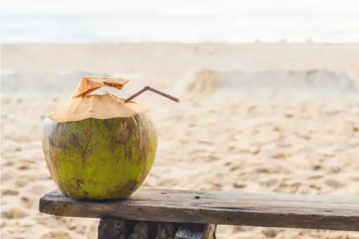 Green coconut on wooden sitting table