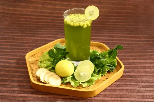 Jaljeera drink in glass with lemons