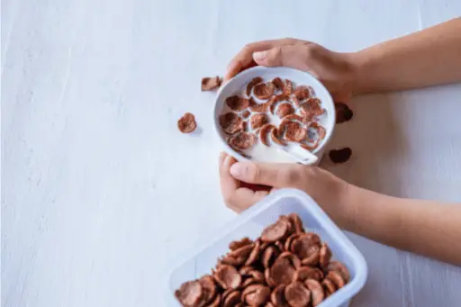 Person eating chocos with milk in a bowl