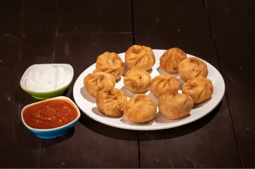 Fried Momos in plate with chilly sauce and mayonnaise