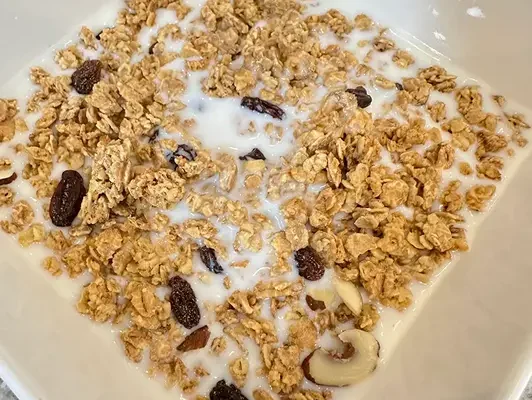 Harvest crunch cereal mixed with milk in bowl